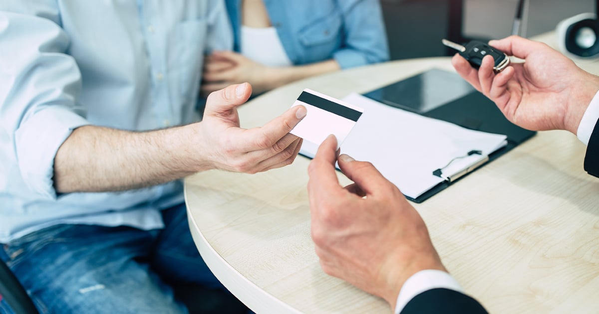 Cropped photo of a salesman taking payment information from a client.